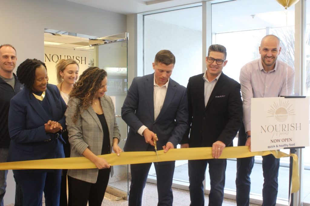 Sophia and Kevin Macauley, (center) the owners of Nourish Markets and Kurtis Van Horn of Adroit Worldwide Media, cut the ribbon on the first fully autonomous store in Delaware. | DBT PHOTO BY KATIE TABELING